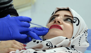 An Iraqi woman gets a lip injection at an aesthetic clinic in the northern city of Mosul. (AFP file photo)